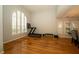 Bright bonus room with hardwood floors, plantation shutters, and exercise equipment at 2206 Green Oaks Ln, Tampa, FL 33612