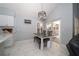 Light-filled dining area with modern chandelier, table, and access to outdoor patio at 2206 Green Oaks Ln, Tampa, FL 33612