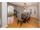 Elegant dining room with hardwood floors, modern chandelier, and plantation shutters at 2206 Green Oaks Ln, Tampa, FL 33612