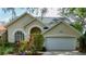 Lovely home with an attached two-car garage and well-maintained landscaping, presenting an inviting front facade at 2206 Green Oaks Ln, Tampa, FL 33612