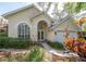 Charming home exterior with manicured landscaping and inviting arched entrance at 2206 Green Oaks Ln, Tampa, FL 33612