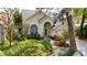 Charming one-story home with a well-manicured lawn, lush landscaping, and inviting entryway at 2206 Green Oaks Ln, Tampa, FL 33612