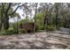 Community gate entrance with brick columns, iron gate, and mature landscaping leading into the property at 2206 Green Oaks Ln, Tampa, FL 33612