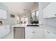 Modern kitchen featuring white cabinets, stainless steel appliances, and quartz countertops at 2206 Green Oaks Ln, Tampa, FL 33612