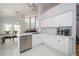Bright kitchen featuring white cabinets, stainless appliances, and eat-in dining area at 2206 Green Oaks Ln, Tampa, FL 33612