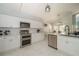 Modern kitchen with white cabinets, stainless steel appliances, and marble-look tile flooring at 2206 Green Oaks Ln, Tampa, FL 33612