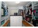 Spacious walk-in closet with custom shelving and an island for organization and storage at 2206 Green Oaks Ln, Tampa, FL 33612