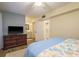 Relaxing bedroom with a TV, adjacent bathroom and laundry, and a soothing color scheme for peaceful nights at 2211 Belleair Rd # D12, Clearwater, FL 33764
