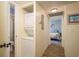 Hallway with in-unit washer and dryer, with access to a bathroom and bedroom, offering convenience at 2211 Belleair Rd # D12, Clearwater, FL 33764