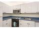 Well-equipped kitchen with white cabinets, modern appliances, and stylish fixtures for an efficient cooking space at 2211 Belleair Rd # D12, Clearwater, FL 33764