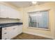 Charming kitchen features white cabinets and modern appliances, all illuminated by natural light at 2211 Belleair Rd # D12, Clearwater, FL 33764