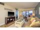 Cozy living room with a comfortable couch, view to a sunroom, and beach house themed decorations at 2211 Belleair Rd # D12, Clearwater, FL 33764
