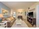 Comfortable living room featuring beach decor, a plush sofa, and a flat-screen TV for relaxation at 2211 Belleair Rd # D12, Clearwater, FL 33764