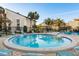 Community pool with beautiful landscaping and seating areas, perfect for relaxation and socializing at 2211 Belleair Rd # D12, Clearwater, FL 33764