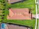 Aerial view of a home with a red tile roof surrounded by a lush green lawn at 29488 Ginnetto Dr, Wesley Chapel, FL 33543