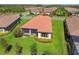 Aerial view of the back of the home featuring a screened lanai and lush landscaping at 29488 Ginnetto Dr, Wesley Chapel, FL 33543
