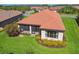 Aerial view showcasing back of home featuring screened lanai and attractive yellow flowering shrubs at 29488 Ginnetto Dr, Wesley Chapel, FL 33543