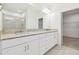 Stylish bathroom featuring granite countertops, double sinks, and a walk-in closet at 29488 Ginnetto Dr, Wesley Chapel, FL 33543