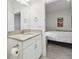 Bright bathroom with a granite vanity, and a view of a bedroom at 29488 Ginnetto Dr, Wesley Chapel, FL 33543