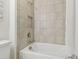 Tile shower and tub offer a relaxing space in this light, bright bathroom at 29488 Ginnetto Dr, Wesley Chapel, FL 33543