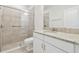 Bathroom with a tiled walk-in shower, granite countertops, and a white vanity at 29488 Ginnetto Dr, Wesley Chapel, FL 33543
