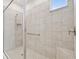 Modern bathroom with glass-enclosed shower and neutral tile at 29488 Ginnetto Dr, Wesley Chapel, FL 33543