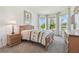 Bright bedroom featuring large windows, a cozy bed, and warm, inviting decor at 29488 Ginnetto Dr, Wesley Chapel, FL 33543