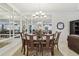 Elegant dining room with a chandelier, round table, and mirrored wall for an open, airy feel at 29488 Ginnetto Dr, Wesley Chapel, FL 33543