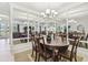 Dining room with natural light, an elegant chandelier, and a mirrored accent wall at 29488 Ginnetto Dr, Wesley Chapel, FL 33543