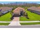 Charming single Gathering home with lush green lawn, attractive roof, and brick paver driveway at 29488 Ginnetto Dr, Wesley Chapel, FL 33543
