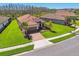 Beautiful single-Gathering home showcasing lush green lawn and brick driveway on a sunny day at 29488 Ginnetto Dr, Wesley Chapel, FL 33543