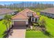 Charming single-Gathering home with well-maintained landscaping, paver driveway, and a two-car garage at 29488 Ginnetto Dr, Wesley Chapel, FL 33543