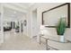 Bright foyer with tile floors, a console table, decorative mirror, and an open view of the living areas at 29488 Ginnetto Dr, Wesley Chapel, FL 33543