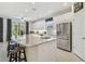 Modern kitchen featuring an island with seating, stainless steel appliances, and sleek cabinetry at 29488 Ginnetto Dr, Wesley Chapel, FL 33543
