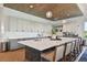 Modern kitchen with a large island, seating, stylish countertops, and ample cabinet space, complemented by modern lighting at 29488 Ginnetto Dr, Wesley Chapel, FL 33543