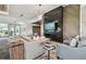 Contemporary living room with stylish sofas, accent wall, modern lighting, and a large flatscreen television at 29488 Ginnetto Dr, Wesley Chapel, FL 33543