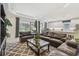 Spacious open-concept living room with modern decor and seamless flow to the kitchen and dining area at 29488 Ginnetto Dr, Wesley Chapel, FL 33543