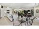 Open-concept living space with granite island, eat-in area, and comfortable seating at 29488 Ginnetto Dr, Wesley Chapel, FL 33543
