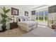 Spacious main bedroom with large window, tray ceiling, and neutral décor at 29488 Ginnetto Dr, Wesley Chapel, FL 33543