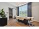 Bright massage room features a modern table, stool, wood floors, sheer window coverings, and sliding barn door at 29488 Ginnetto Dr, Wesley Chapel, FL 33543