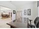 Spacious office area with large desk and view to open dining room area at 29488 Ginnetto Dr, Wesley Chapel, FL 33543