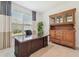 Office with large desk and built in curio cabinet at 29488 Ginnetto Dr, Wesley Chapel, FL 33543