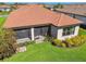Home featuring red tile roof, screened-in lanai, and landscaping at 29488 Ginnetto Dr, Wesley Chapel, FL 33543