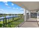 Scenic balcony view overlooking a serene lake, manicured backyard, and neighboring houses at 33105 Kateland Dr, Wesley Chapel, FL 33545
