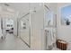 Modern bathroom featuring glass enclosed shower, white marble floors, and ample natural light at 33105 Kateland Dr, Wesley Chapel, FL 33545