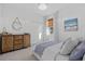 Bright bedroom features a decorative dresser, closet, with an accent painting to bring in a modern vibe at 33105 Kateland Dr, Wesley Chapel, FL 33545