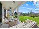 Inviting covered patio overlooking a manicured lawn and pond, perfect for relaxation and outdoor living at 33105 Kateland Dr, Wesley Chapel, FL 33545