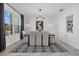 Elegant dining room with modern light fixture, decorative rug, and neutral decor at 33105 Kateland Dr, Wesley Chapel, FL 33545