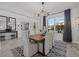 Dining area with a square wood table, modern lighting, and large windows at 33105 Kateland Dr, Wesley Chapel, FL 33545