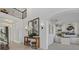 Elegant foyer featuring a console table with decorative mirrors, lighting, and access to stairs and study at 33105 Kateland Dr, Wesley Chapel, FL 33545